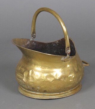 A brass helmet shaped coal scuttle 25cm x 30cm (some dents)