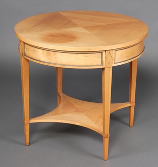 A Continental Empire style circular quarter veneered satinwood occasional table, raised on square supports with shaped undertier, base marked TKA 67cm h x 75cm diam. 