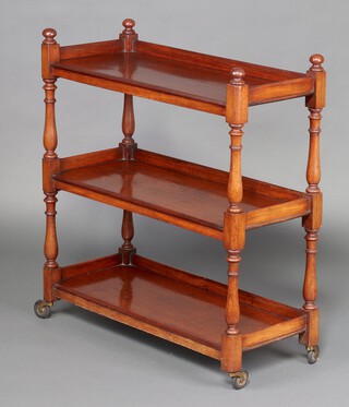 A Victorian rectangular mahogany 3 tier buffet, raised on turned supports with casters 94cm h x 86cm w x 37cm d 