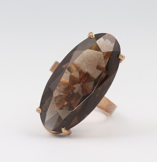A 9ct yellow gold oval smoky quartz dress ring, size J 1/2, 5.7 grams 
