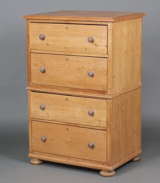 A Victorian pine chest on chest, both sections fitted 2 long drawers with replacement turned handles, raised on bun feet 122cm h x 80cm w x 58cm d 