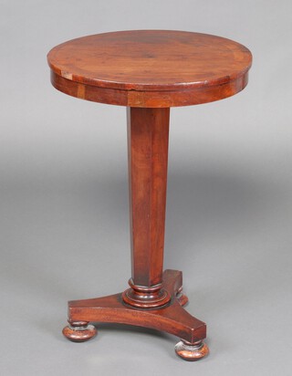 A William IV circular mahogany occasional table raised on a waisted chamfered column with triform base and bun feet 72cm h x 47cm diam. 
