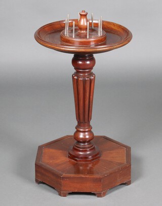 A circular turned mahogany dish top sewing/bobbin stand, raised on turned and fluted column with octagonal base 62cm h x 41cm diam. (made up), having a pin cushion to the top 
