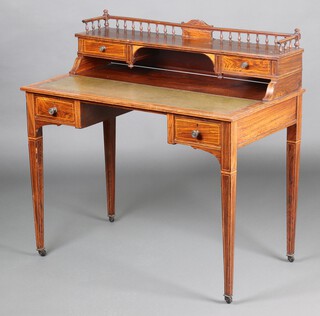 A Victorian inlaid rosewood writing table, the raised super structure to the back with bobbin turned 3/4 gallery and 2 short drawers above a green leather writing surface, the base fitted 2 short drawers, raised on square tapered supports with ceramic casters 96cm h x 99cm w x 56cm d 