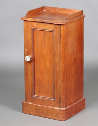 A Victorian mahogany bedside cabinet with 3/4 gallery, enclosed by a panelled door with glass faceted handle, raised on a platform base 79cm h x 39cm w x 33cm d 