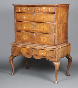 A Queen Anne inlaid figured walnut and oak lined chest on stand, the top quarter veneered and crossbanded, fitted 2 short and 3 long graduated drawers, the base 1 long drawer, raised on cabriole supports 155cm h x 104cm w x 63cm d 
