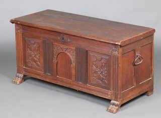 An 18th Century oak coffer  with hinged lid, complete with iron drop handles to the sides, original hinges and candle box to the interior, raised on carved paw feet 60cm h x 123cm w x 55cm d 