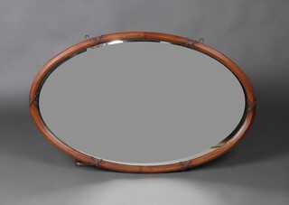 An Edwardian oval plate wall mirror contained in a walnut reeded frame 97cm x 61cm 