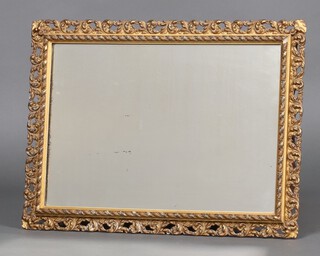 A 19th Century rectangular plate mirror contained in a carved pierced hardwood and plaster frame 57cm h x 41cm w 