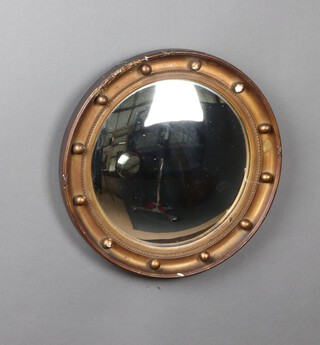 A 1920's circular Regency style convex wall mirror contained in a wooden and gilt plaster ball studded frame 40cm diam. 