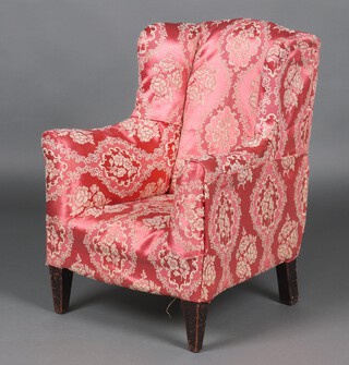A child's  Edwardian winged armchair upholstered in pink and white floral material, 71cm x 51cm x 53cm 