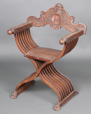 A carved walnut Savonarola folding chair, the back decorated a crest with lion, the centre roundel carved a hooded figure 95cm h x 70cm w x 52cm d 