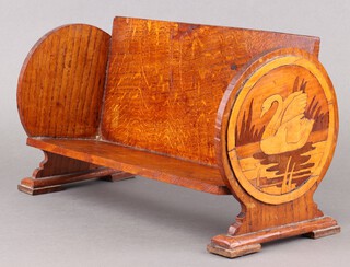 An Art Nouveau inlaid oak book trough, the rounded ends inlaid parquetry panels of a swan 20cm x 39cm w x 15cm 