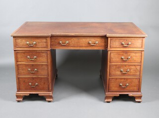 A mahogany inverted breakfront desk with brown writing surface, fitted 1 long and 6 short drawers, raised on bracket feet 74cm h x 137cm w x 76cm d 