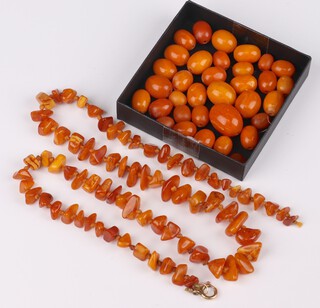 Thirty-four honeycomb amber beads, loose, 43 grams, together with a natural amber bead necklace 65cm 