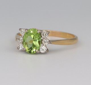 An 18ct yellow gold oval peridot and diamond ring, the centre stone 0.75ct, the 6 brilliant cut diamonds 0.24ct, size R, 3.6 grams