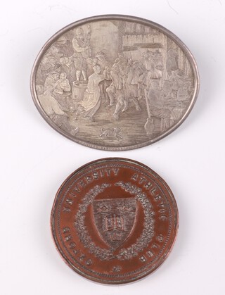 A silvered oval brooch, an interior scene Tenniers, oval 6cm and a 1923 bronze Oxford University Athletic club medal 