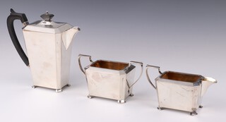 An Art Deco silver 3 piece tea set with ebony mounts, the teapot Chester 1931, the sugar bowl and milk jug Birmingham 1931, gross weight 928 grams 