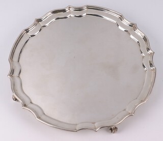 A silver salver with pie crust rim on scroll feet Birmingham 1987, 25cm, 482 grams 