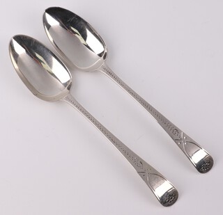 A pair of George III silver bright cut table spoons, London 1801, 94 grams