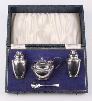 A silver 3 piece condiment with spoon, Birmingham 1966, 126 grams, cased 