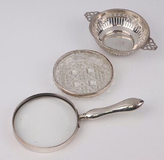A circular silver dish with pierced decoration Birmingham 1939, 14.5cm, a silver mounted magnifying glass and a silver mounted dish 