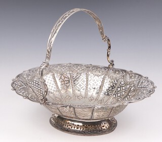 A good Victorian pierced and repousse silver basket with swing handle, decorated with scrolls, having an engraved armorial, Sheffield 1888, 33cm, maker Martin Hall and Co., 680 grams 