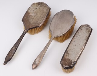 A silver backed engine turned dressing table set comprising 2 hair brushes and 1 clothes brush, Sheffield 1930 