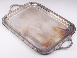 A silver plated 2 handled rounded rectangular tray with Cymric decoration 64cm 