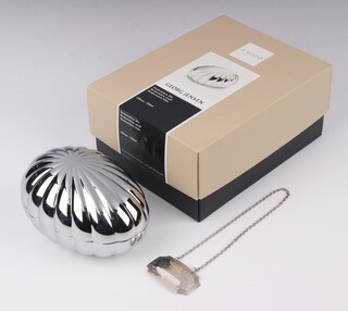 A modern Georg Jensen silver plated bombonniere and cover 12cm, boxed, together with a silver Sherry label
