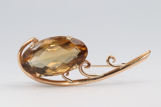 A 9ct yellow gold smoky quartz brooch 60mm, the stone 25mm x 15mm, gross weight 13 grams 