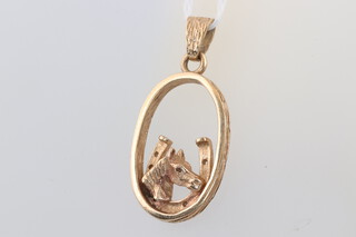 A 9ct yellow gold pendant with a horse shoe and horses head 4.3 grams 