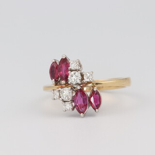 An 18ct yellow gold mid-century ruby and diamond ring, 4 elliptical rubies 0.40ct, the 6 brilliant cut diamonds 0.14ct, size O 1/2, 4.5 grams 