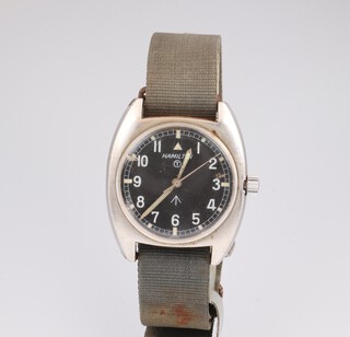 A gentleman's Hamilton black dial steel cased British Military wristwatch, the dial named and with a capital T, the case numbered W06645/99 23/8290 2914/75 35mm, with original canvas strap (in working order) 