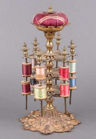 A Victorian pierced brass 3 tier cotton reel/bobbin stand, raised on a Rococo style base 28cm x 15cm 