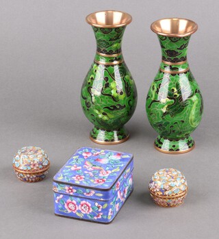 A blue ground cloisonne enamelled box with floral and butterfly decoration 5cm x 6cm x 9cm (chip to left edge),  a pair of green ground and floral patterned cloisonne enamelled club shaped vases 15cm  and a pair of circular champleve enamelled jars and covers 3cm 