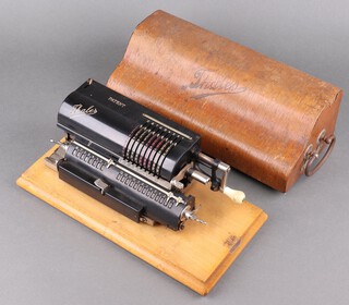 A Thales Patent Model A calculator, complete with wooden carrying case 