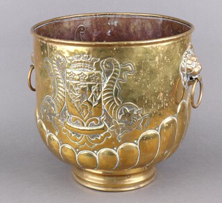 A 19th Century circular Dutch embossed brass twin handled jardiniere with rampant lion coat of arms supported by cornucopias with brass ring drop handles, raised on a circular foot 29cm x 28cm 