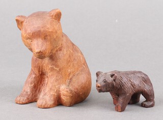 A Swiss Black Forrest carved wooden figure of a walking bear 4cm (both front paws damaged), together with a carved figure of a seated bear 9cm 