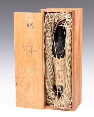 A bottle of Grand Siecle 1914 cognac, contained in a wooden carrying case 