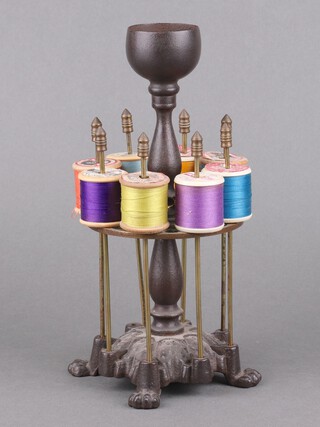 A Victorian iron and brass 2 tier bobbin/cotton reel stand raised on a Gothic style leaf base with paw feet 25cm x 11cm 