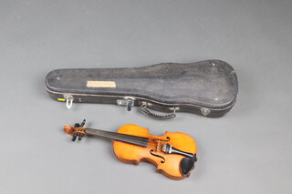 A child's 1/8 violin with single back 10", unlabelled, contained in a fibre carrying case 
