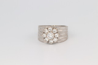 A white gold, testing as 18ct, diamond cluster ring, the diamonds approx. 1.3ct, size O 1/2m 6.3 grams 