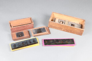 An unmarked coloured magic lantern slide of Queen Victoria, an H Hughes of 59 Fenchurch Street, London, 2 black and white magic lantern slides of The Prince and Princess of Wales and various other children's story magic lantern slides 7cm x 22cm, contained in a wooden box 