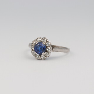 A 9ct yellow gold sapphire and diamond cluster ring, the sapphire 0.5ct, the brilliant cut diamonds 0.10ct, size L, 1.8 grams 