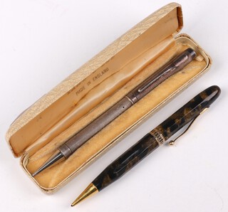 An engine turned silver Yard O'Led propelling pencil and a lady's gilt metal mounted green marble propelling pencil 