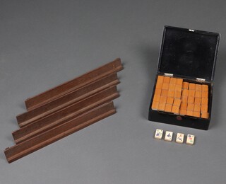 A Mahjong set comprising 144 bone and bamboo tiles, contained in a lacquered box together with 4 wooden walls 
