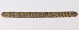 A brass lifeboat nameplate from the SS Britannic circa 1914, 3cm x 45cm.  HMHS Britannic was the third and final vessel of the White Star Line's Olympic class of ocean liners and the second White Star ship to bear the name Britannic.  She was the younger sister of RMS Olympic and RMS Titanic and was intended to enter service as a transatlantic passenger liner.  She operated as a hospital ship from 1915 until her sinking near the Greek island of Kea in the Aegean Sea on November 1916.  At the time she was the largest hospital ship in the world, and the largest vessel built in Britain.   On the morning of 21 November 1916, she hit a naval mine of the Imperial German Navy near the Greek island of Kea and sank 55 minutes later, killing 30 of 1,066 people on board, the 1,036 survivors were rescued from the water and from lifeboats. 