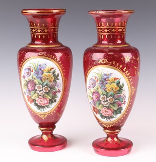 A pair of 19th Century Continental Bohemian ruby glass vases with gilt decoration and panels of spring flowers 30cm 