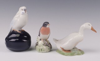 A Royal Copenhagen figure of a seated budgerigar 4682 15cm (broken tail), a ditto of a Robin 1516 12cm and a goose 1192 13cm 